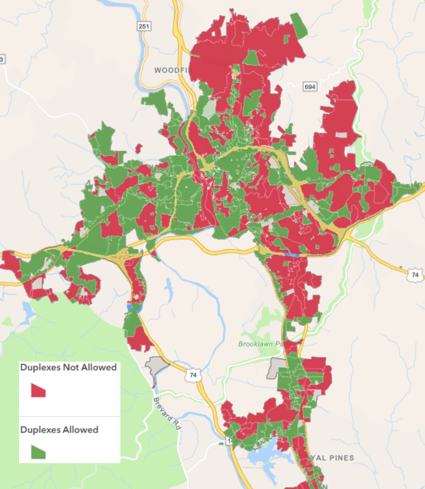 A color-coded map of Asheville, with roughly half of the land area colored red, indicating that duplexes are not a permitted use in these areas.