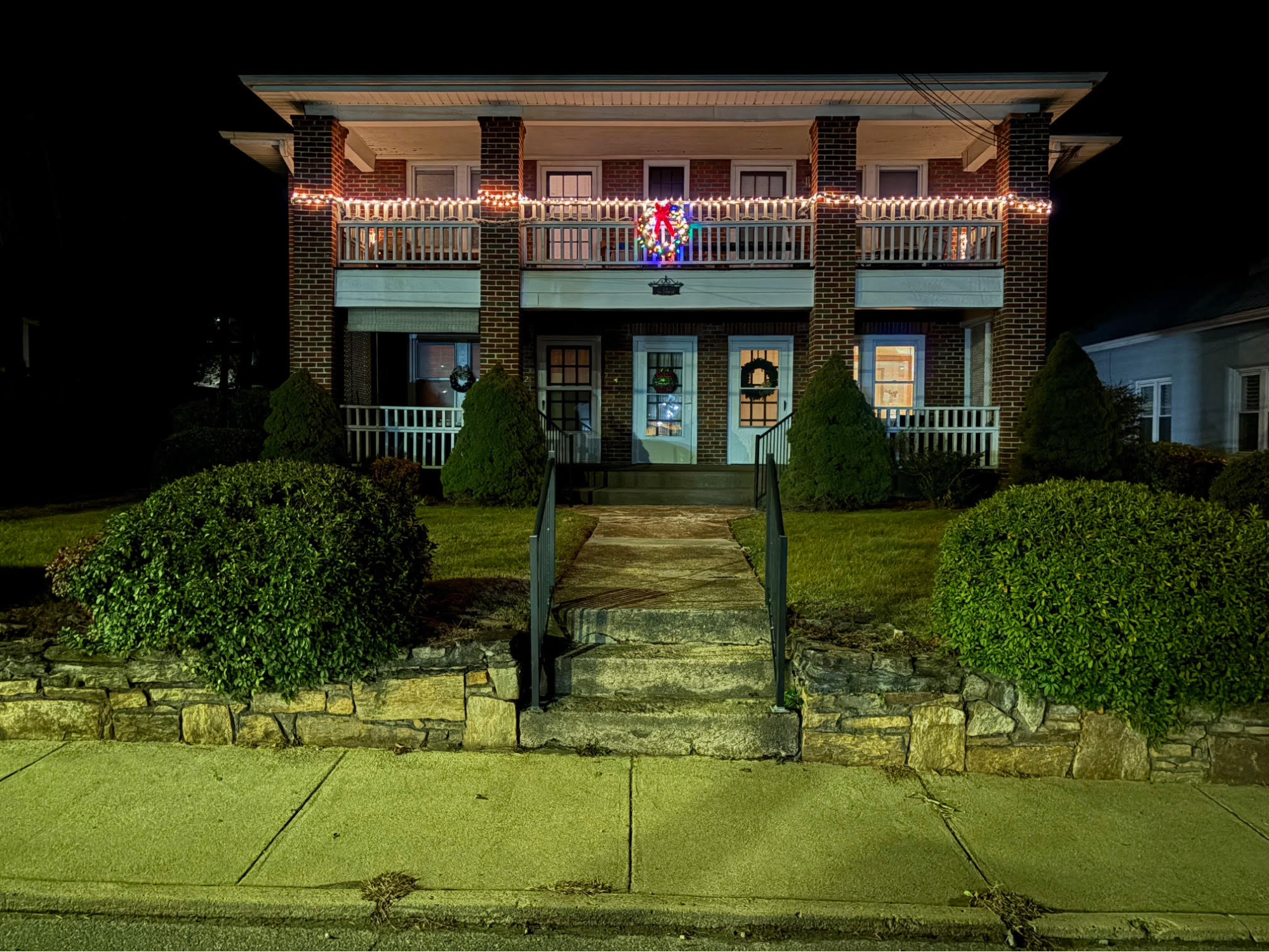 A photograph of a two story residential building.