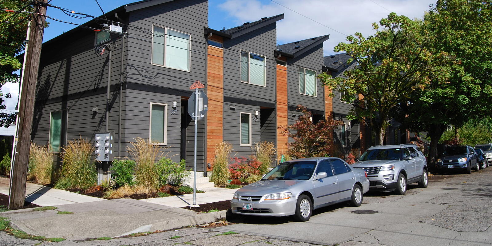 A photograph of contemporary-styled two-story townhomes.