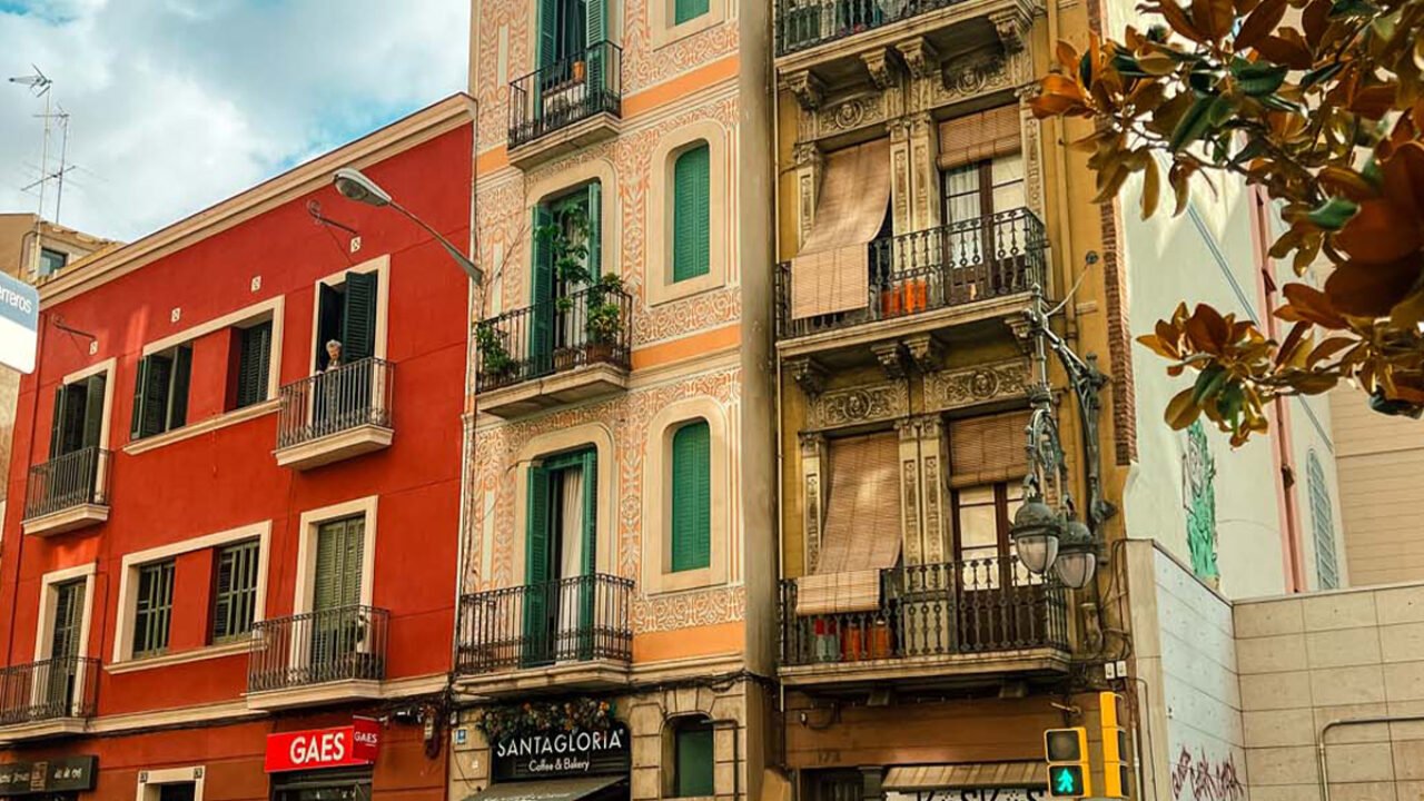 A variety of skinny buildings on an urban streetscape.
width: 1280
height: 720
